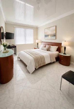 a spacious bedroom with a bed a couch and a window