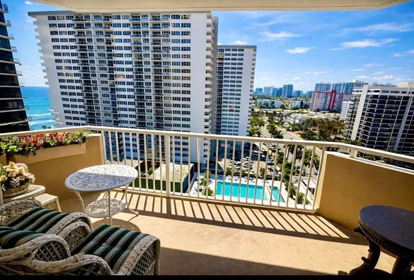 a view of a balcony with furniture