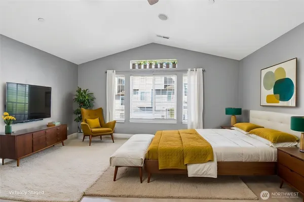 a bedroom with a bed and glass windows