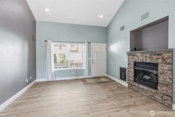 a view of empty room with fireplace and fan