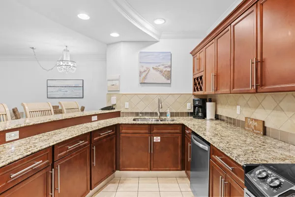 a kitchen with stainless steel appliances granite countertop a sink stove and cabinets