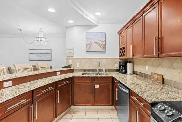 a kitchen with stainless steel appliances granite countertop a sink stove and cabinets