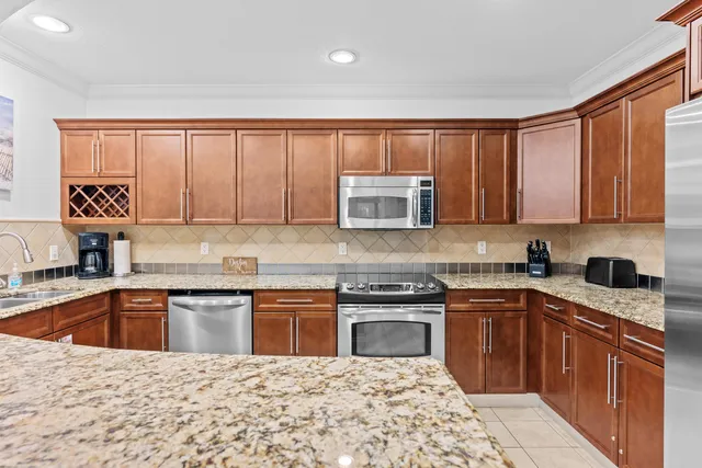 a kitchen with stainless steel appliances granite countertop a sink stove and cabinets