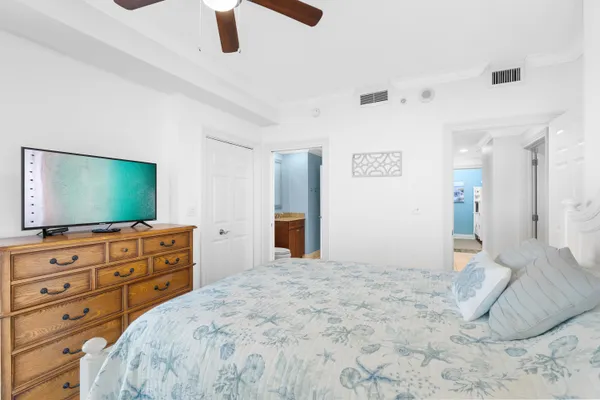 a bedroom with a bed and a flat screen tv