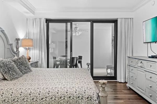 a bedroom with a large bed and a dresser