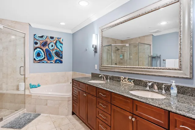 a bathroom with a granite countertop tub sink and mirror