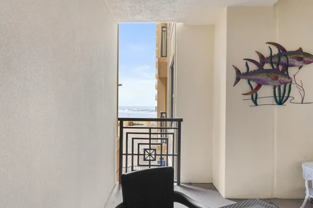 an entryway with a table and chairs