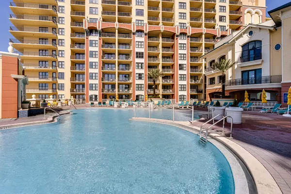 a view of a swimming pool with outdoor seating