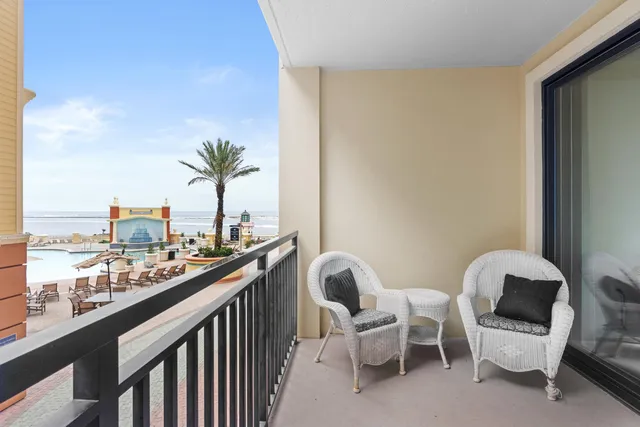 a view of a chairs and table in a balcony