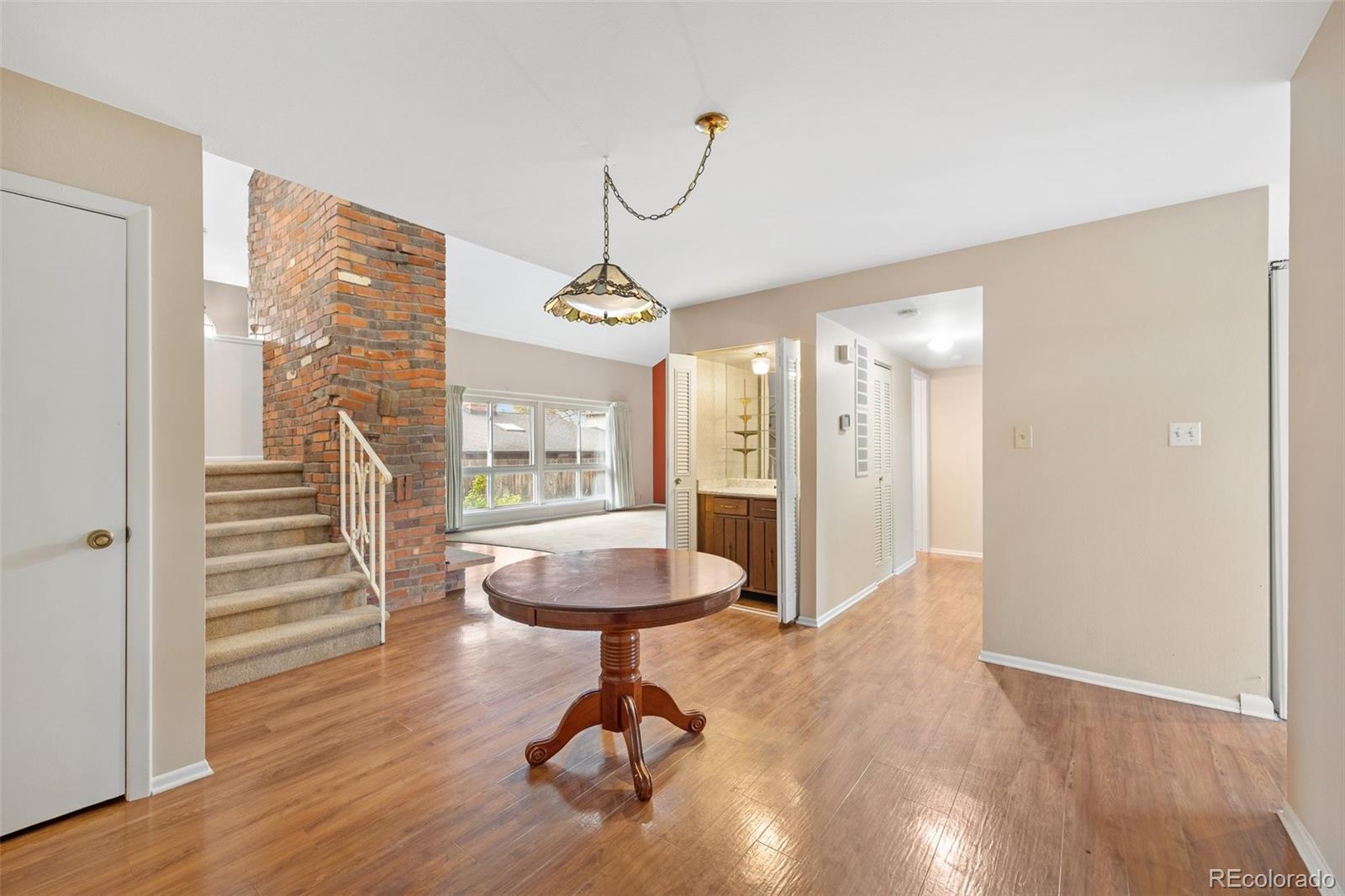 6495 East Happy Canyon Road, Unit 171 Denver, CO 80237 - Photo 11 of 27 a view of a room with wooden floor and windows