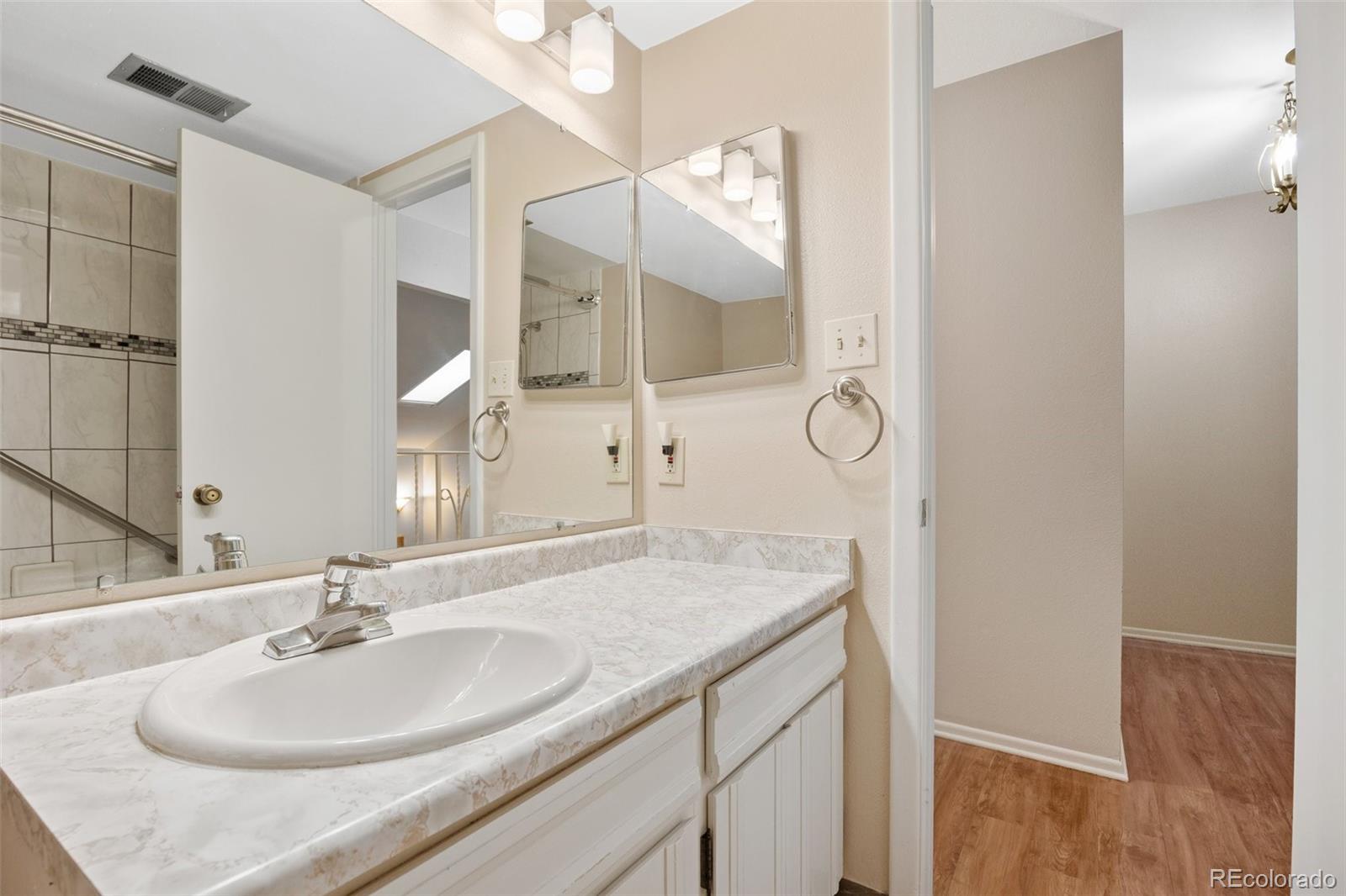 6495 East Happy Canyon Road, Unit 171 Denver, CO 80237 - Photo 16 of 27 a bathroom with a sink and a mirror