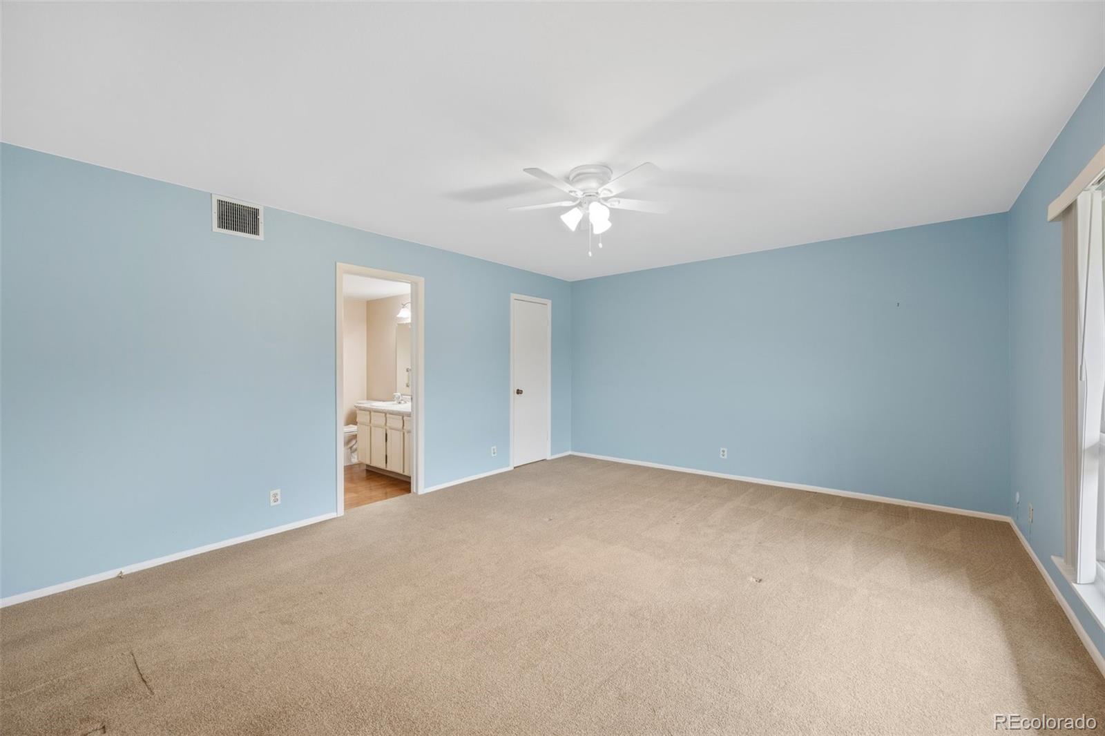 6495 East Happy Canyon Road, Unit 171 Denver, CO 80237 - Photo 19 of 27 a view of an empty room with a ceiling fan