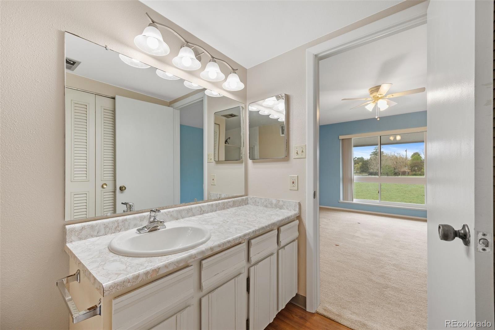 6495 East Happy Canyon Road, Unit 171 Denver, CO 80237 - Photo 20 of 27 a bathroom with a sink double vanity and a mirror