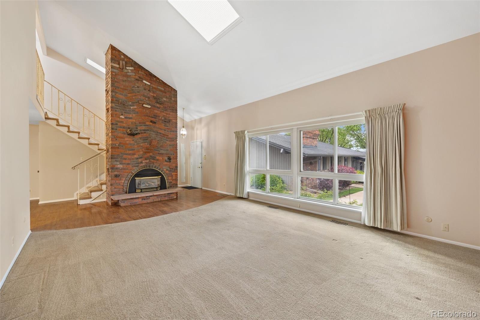 6495 East Happy Canyon Road, Unit 171 Denver, CO 80237 - Photo 2 of 27 a view of a livingroom with a fireplace and large window