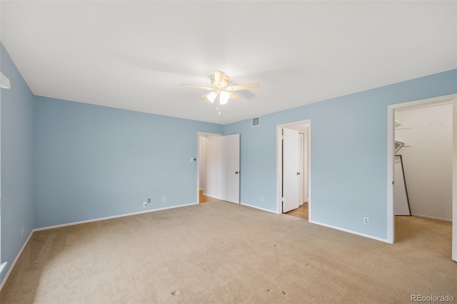 6495 East Happy Canyon Road, Unit 171 Denver, CO 80237 - Photo 22 of 27 an empty room with closet and a ceiling fan