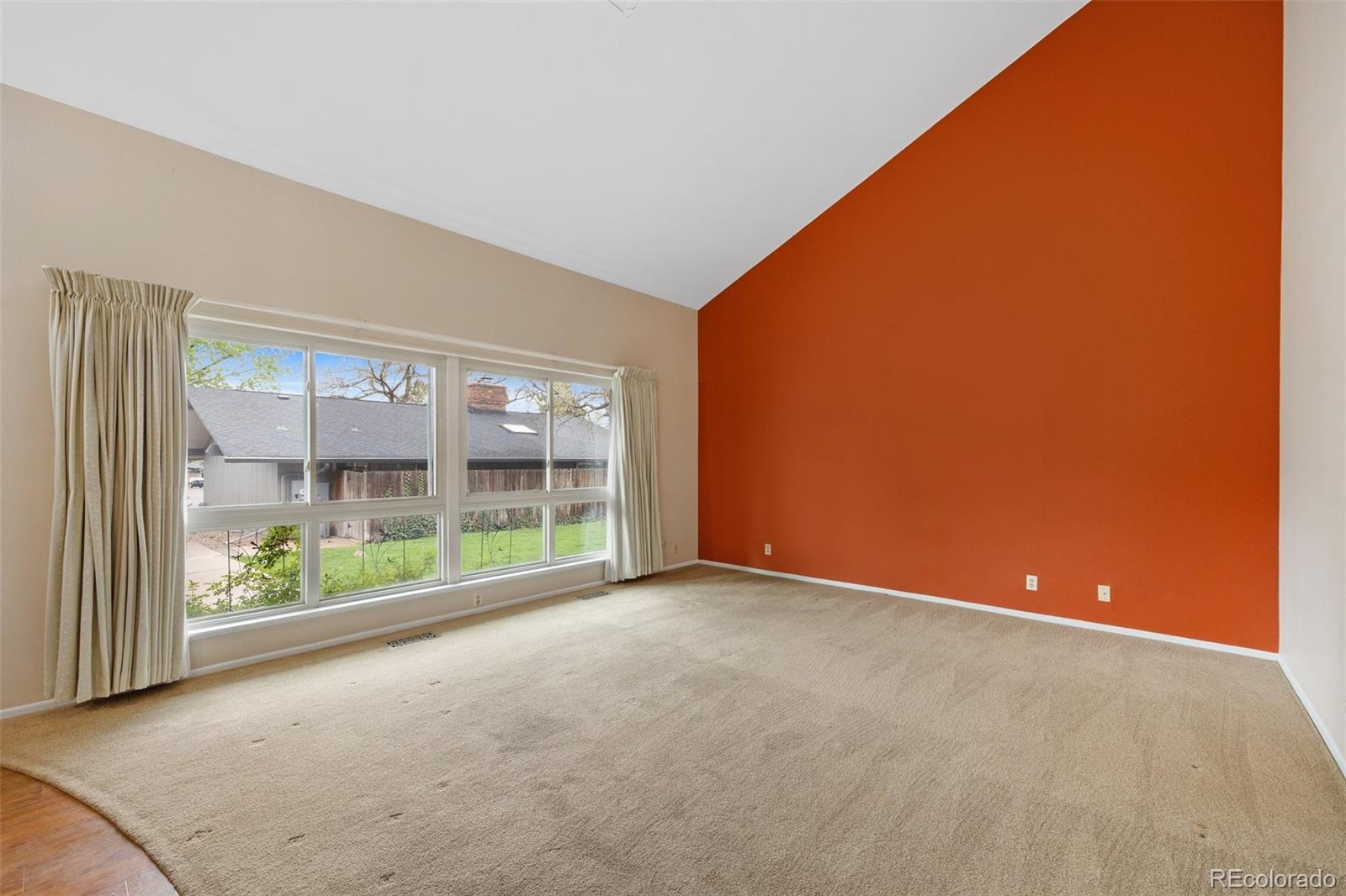6495 East Happy Canyon Road, Unit 171 Denver, CO 80237 - Photo 4 of 27 an empty room with wooden floor and windows