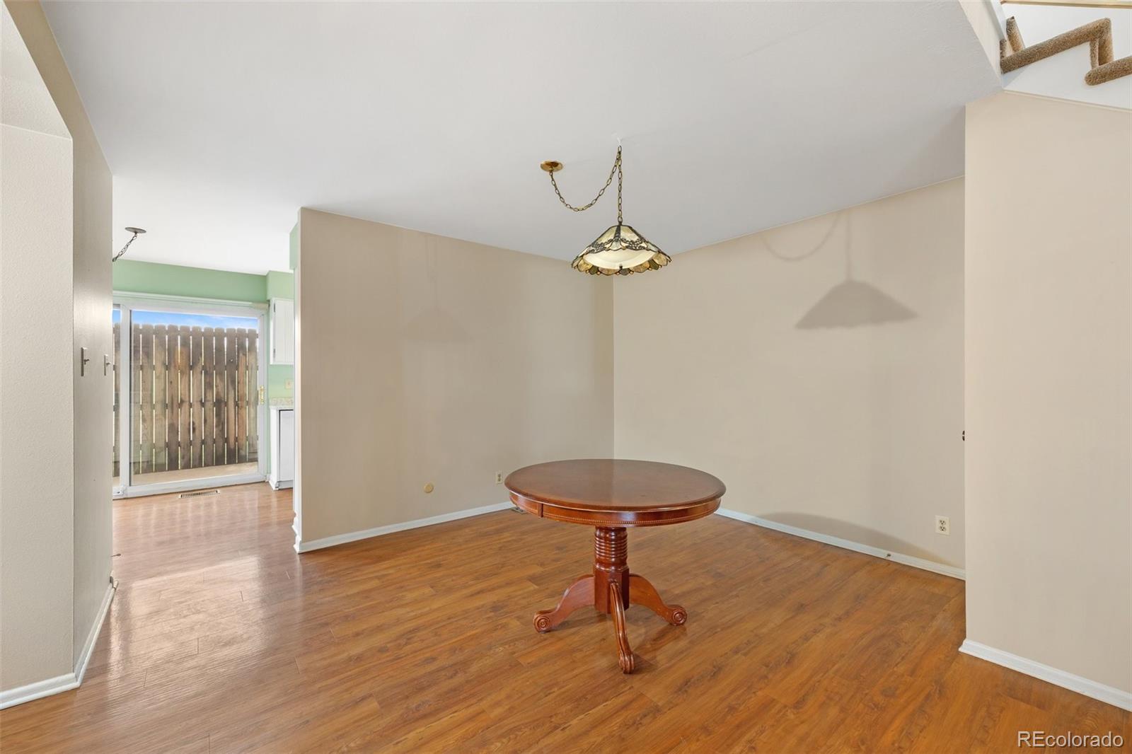 6495 East Happy Canyon Road, Unit 171 Denver, CO 80237 - Photo 5 of 27 a view of an empty room with a window and wooden floor