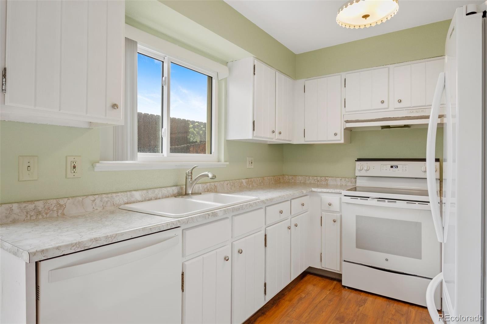 6495 East Happy Canyon Road, Unit 171 Denver, CO 80237 - Photo 7 of 27 a kitchen with white cabinets appliances and sink