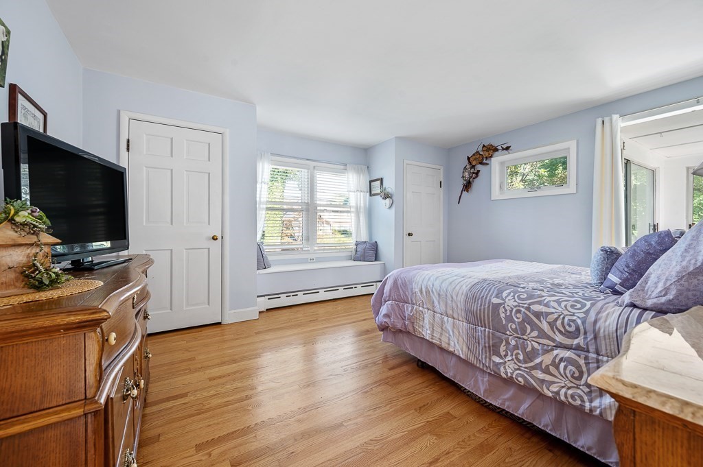 298 Thompson Road Webster, MA 01570 - Photo 8 of 42 a bedroom with a bed and a flat screen tv