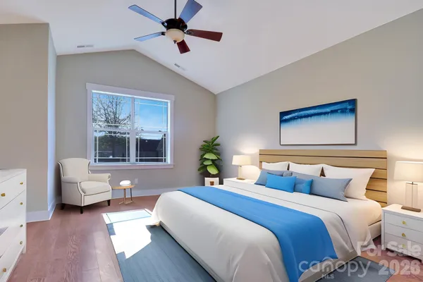 a bedroom with a large bed and a chandelier