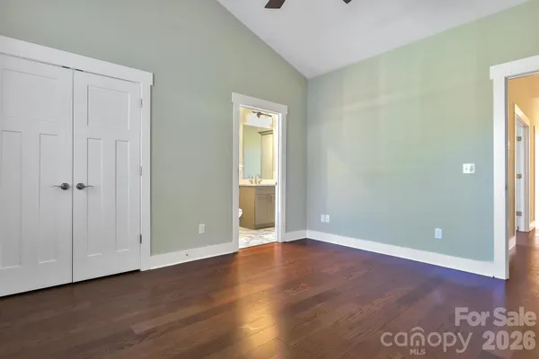 an empty room with wooden floor and closet