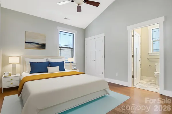 a bedroom with a large bed and a window