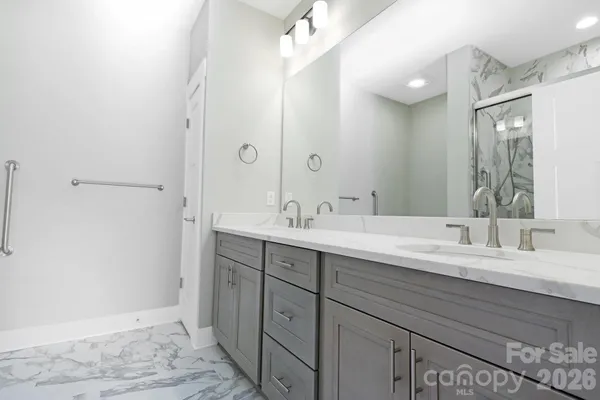 a bathroom with a double vanity sink mirror and double
