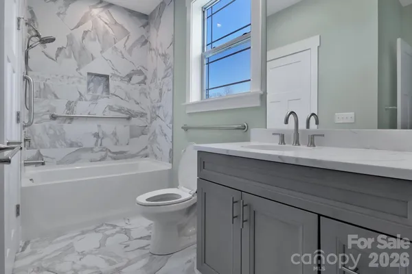 a bathroom with a sink toilet vanity and bathtub