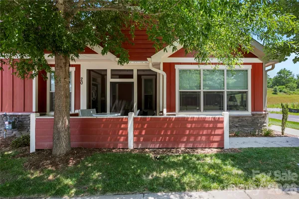 a view of a house with a yard and sitting area