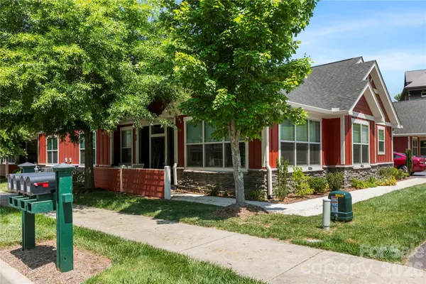 a view of a house with yard and sitting area