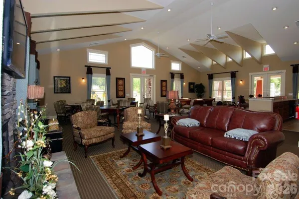 a living room with furniture a large window and a fireplace