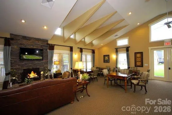 a room with lots of furniture and view kitchen