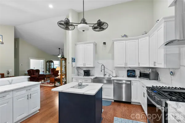 a kitchen with a sink a stove and cabinets