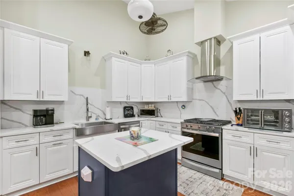 a kitchen with a sink a stove and cabinets