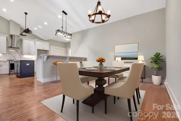 a view of a dining room with furniture wooden floor and chandelier