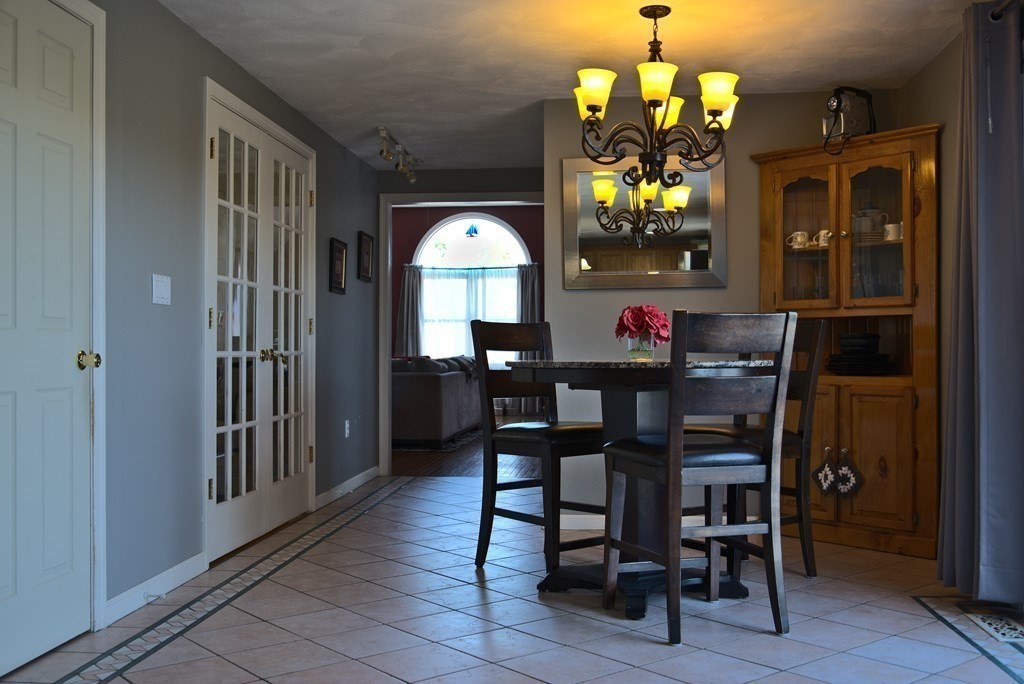 8 Sparrow Road Stoughton, MA 02072 - Photo 11 of 28 a view of a dining room with furniture and chandelier