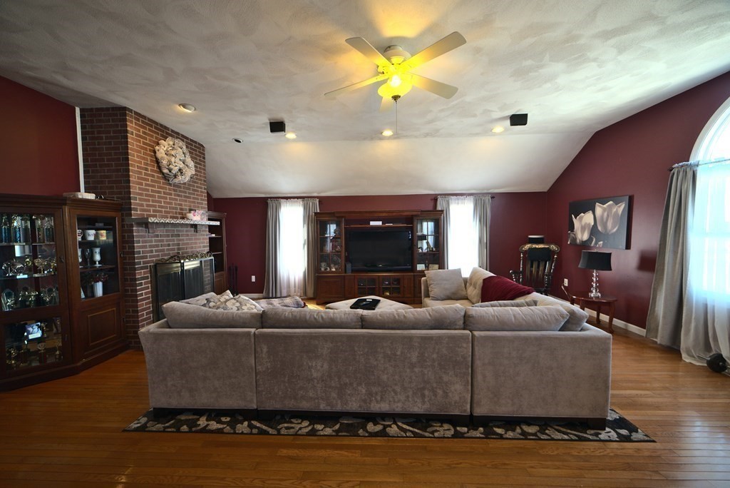 8 Sparrow Road Stoughton, MA 02072 - Photo 12 of 28 a living room with fireplace furniture and a wooden floor