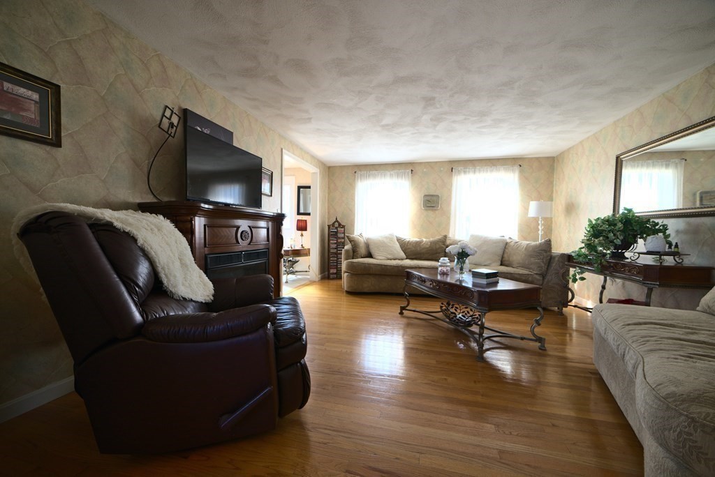 8 Sparrow Road Stoughton, MA 02072 - Photo 18 of 28 a living room with furniture flat screen tv and wooden floor