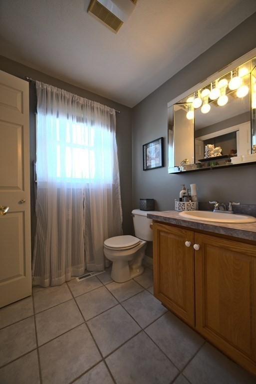 8 Sparrow Road Stoughton, MA 02072 - Photo 20 of 28 a spacious bathroom with a toilet sink and mirror