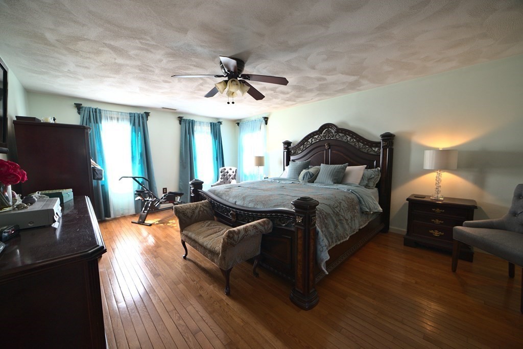 8 Sparrow Road Stoughton, MA 02072 - Photo 22 of 28 a bedroom with a bed and wooden floor
