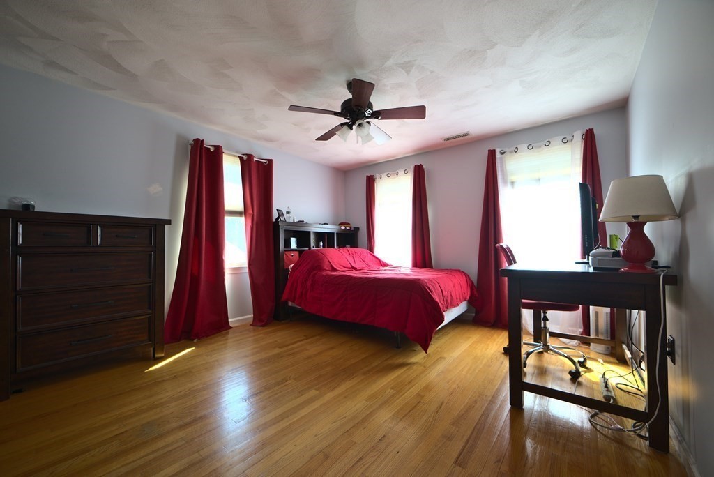8 Sparrow Road Stoughton, MA 02072 - Photo 23 of 28 a bedroom with a bed and a chandelier