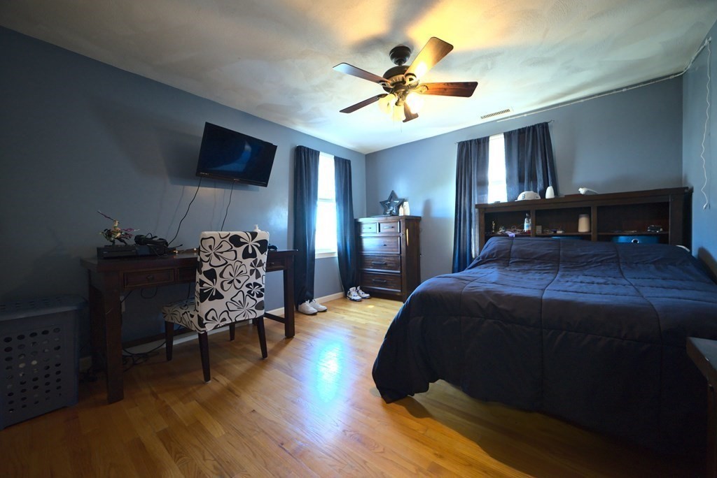 8 Sparrow Road Stoughton, MA 02072 - Photo 24 of 28 a bedroom with a bed and a chandelier