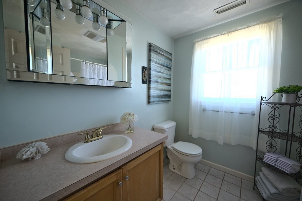 8 Sparrow Road Stoughton, MA 02072 - Photo 26 of 28 a bathroom with a granite countertop sink toilet and shower