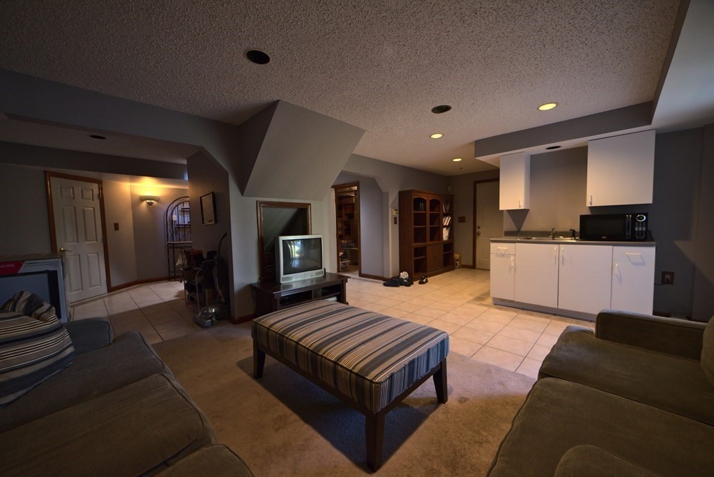 8 Sparrow Road Stoughton, MA 02072 - Photo 27 of 28 a living room with furniture and a kitchen