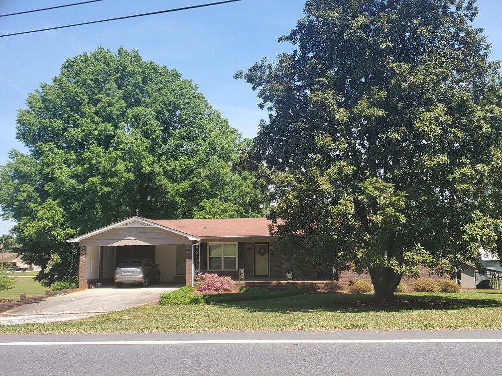 320 Cherokee Road Cedartown, GA 30125 - Photo 1 of 1 a front view of a house with a yard garage and outdoor seating