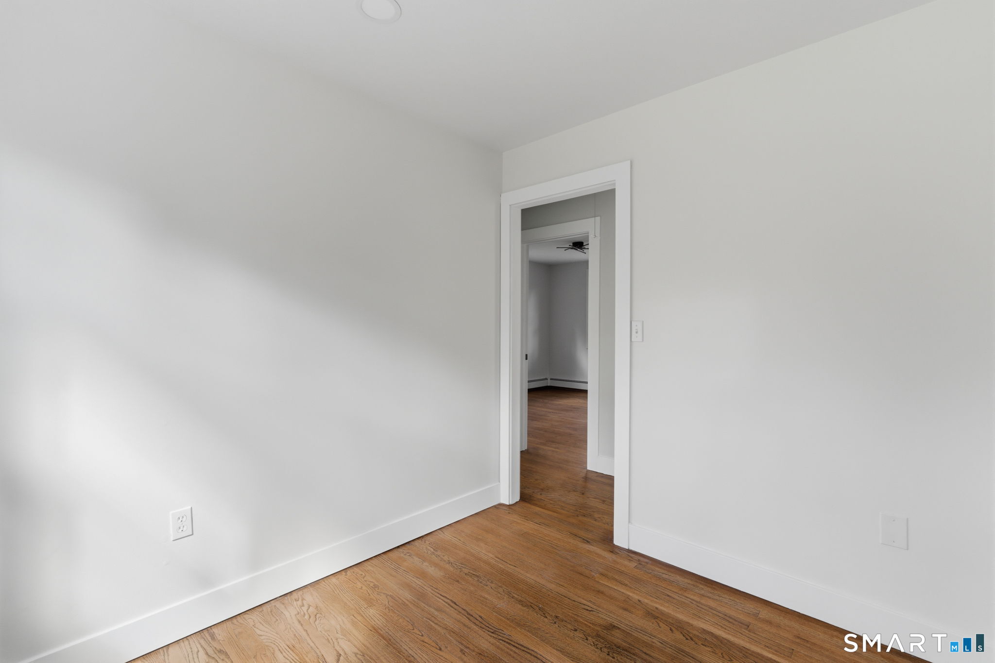 16 Beverly Road East Lyme, CT 06357 - Photo 25 of 40 a view of an empty room with wooden floor and closet