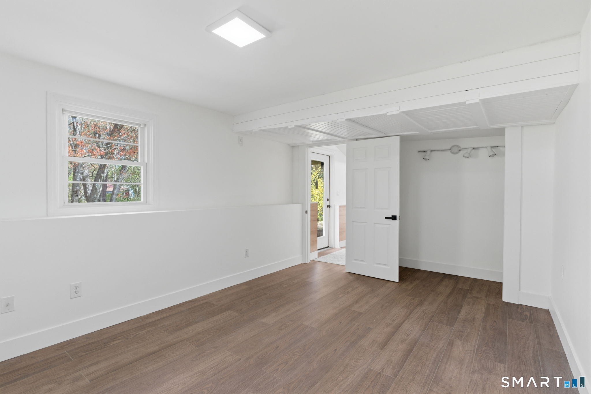 16 Beverly Road East Lyme, CT 06357 - Photo 40 of 40 a view of an empty room with wooden floor and a window