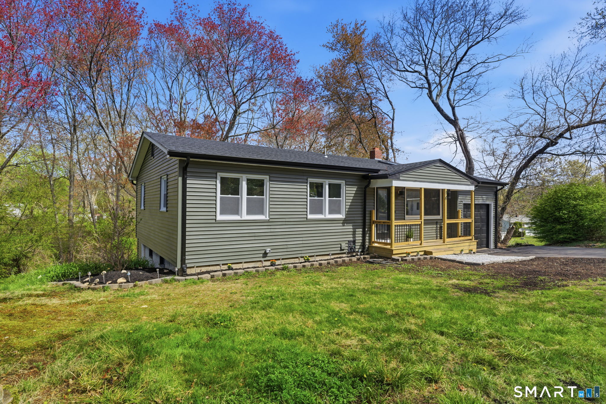 16 Beverly Road East Lyme, CT 06357 - Photo 4 of 40 a front view of house with yard and trees in the background