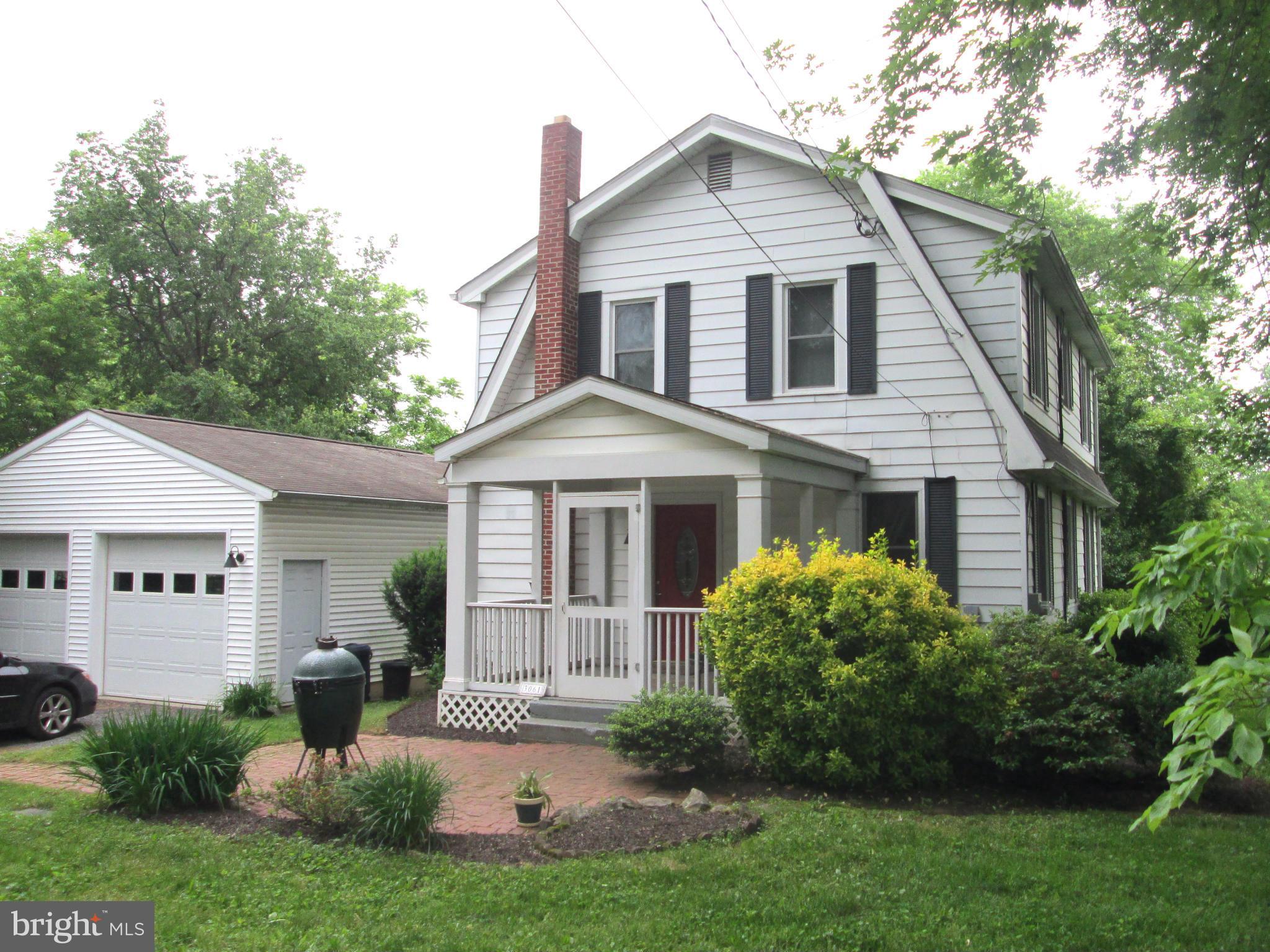 3061 Evans Road Riva, MD 21140 - Photo 1 of 22 a front view of a house with a yard and potted plants