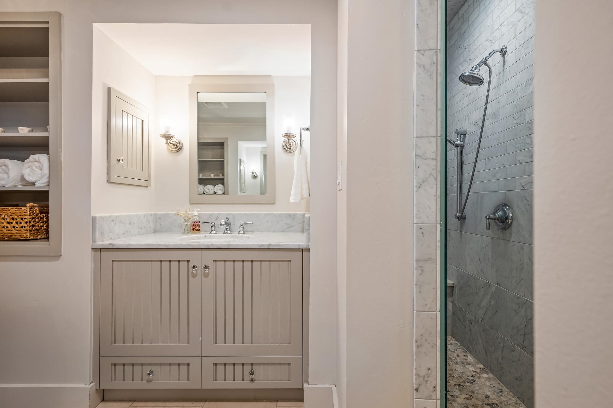 65 Riviera Cove Fredericksburg, TX 78624 - Photo 12 of 26 a bathroom with a shower sink and mirror